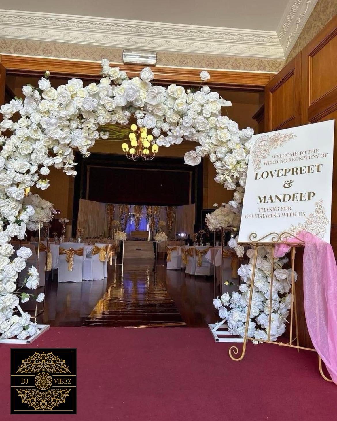White floral entrance arch styling at a New Zealand wedding ceremony